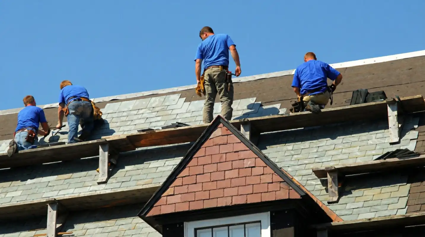 Roof replacement in progress with a team of professional contractors installing new shingles on a residential home in Charlotte, NC