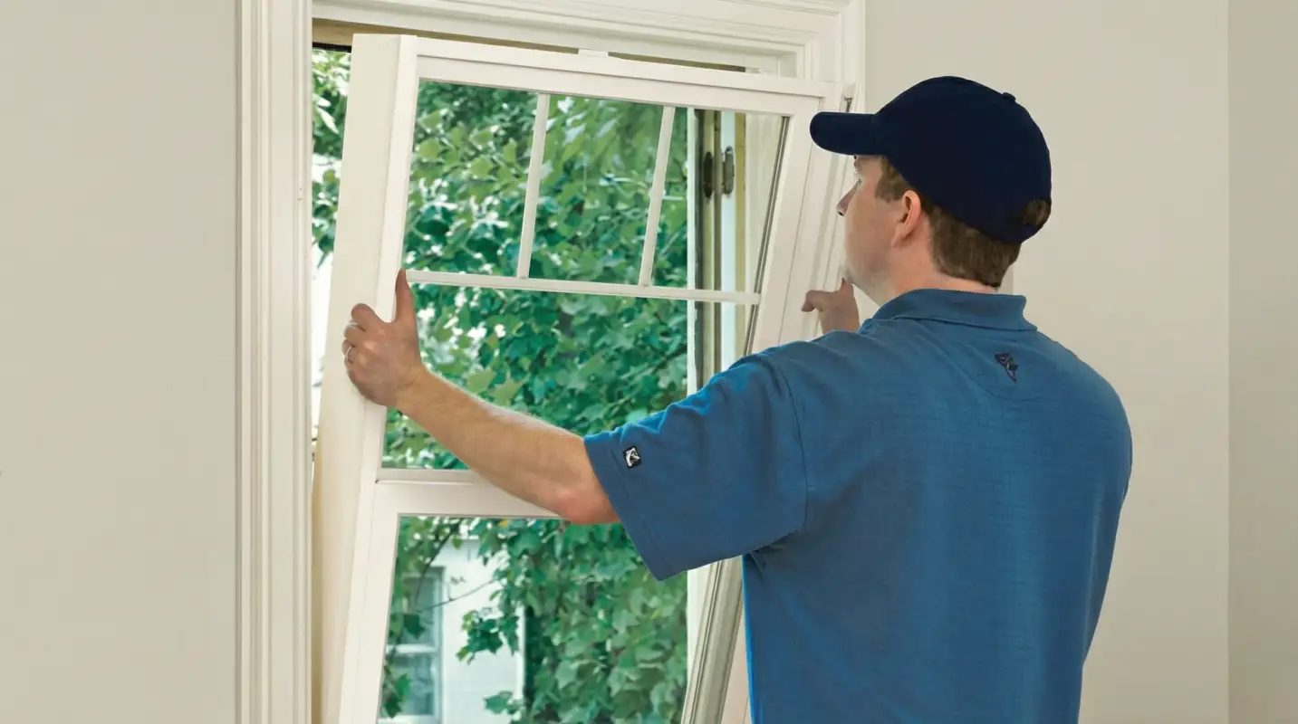 Professional contractors performing a residential window insulation and replacement service in Charlotte, NC
